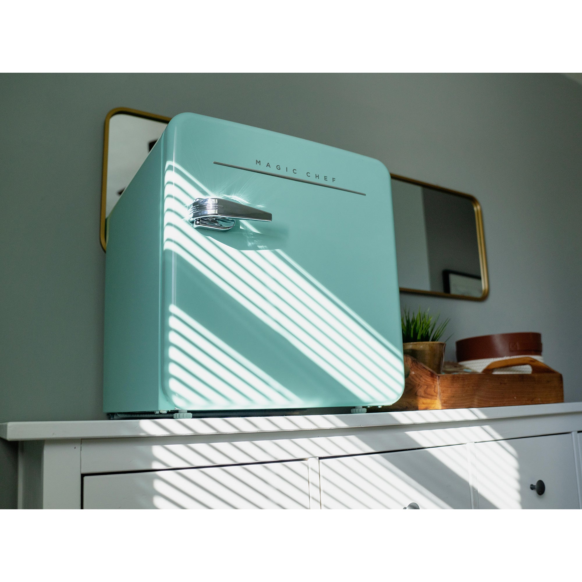 The Magic Chef 1.6 cu. ft. Retro Mini Fridge in mint green is a